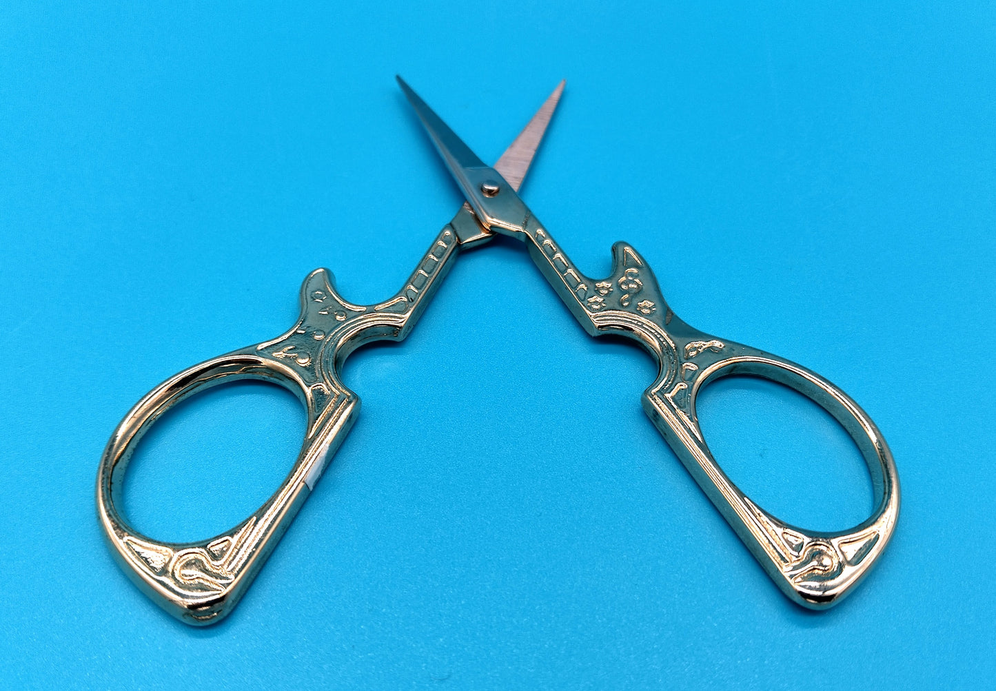 Guitar Scissors. Add a touch of creativity and precision to your sewing projects with the Guitar Shape Stainless Steel Embroidery Scissors.