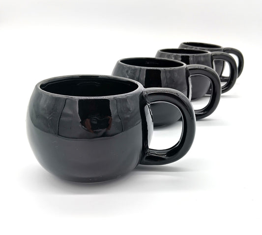 Black Mugs. 4 Pcs. Black.  Add a touch of elegance to your drinkware collection with our 4-piece porcelain mug set.