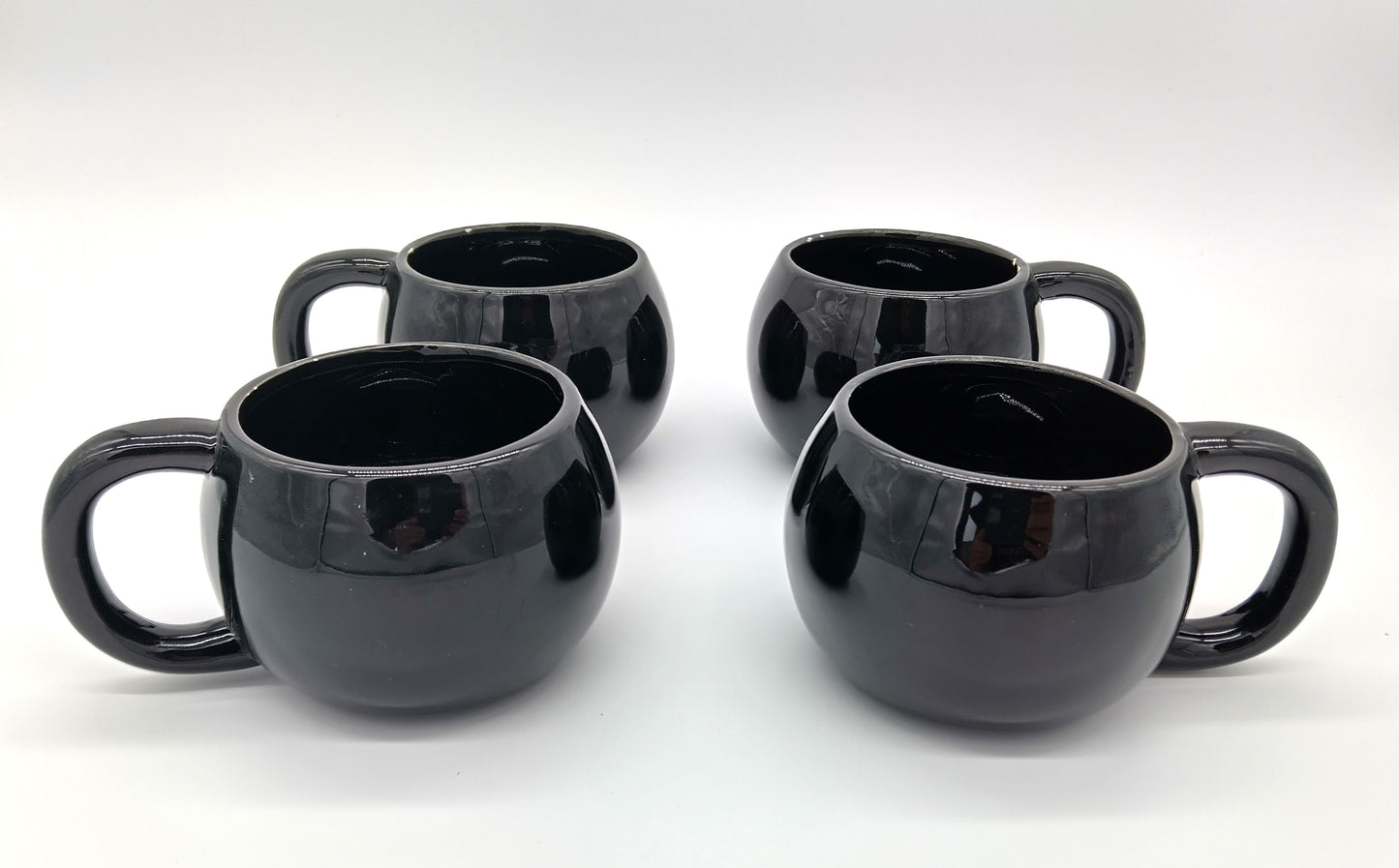 Black Mugs. 4 Pcs. Black.  Add a touch of elegance to your drinkware collection with our 4-piece porcelain mug set.