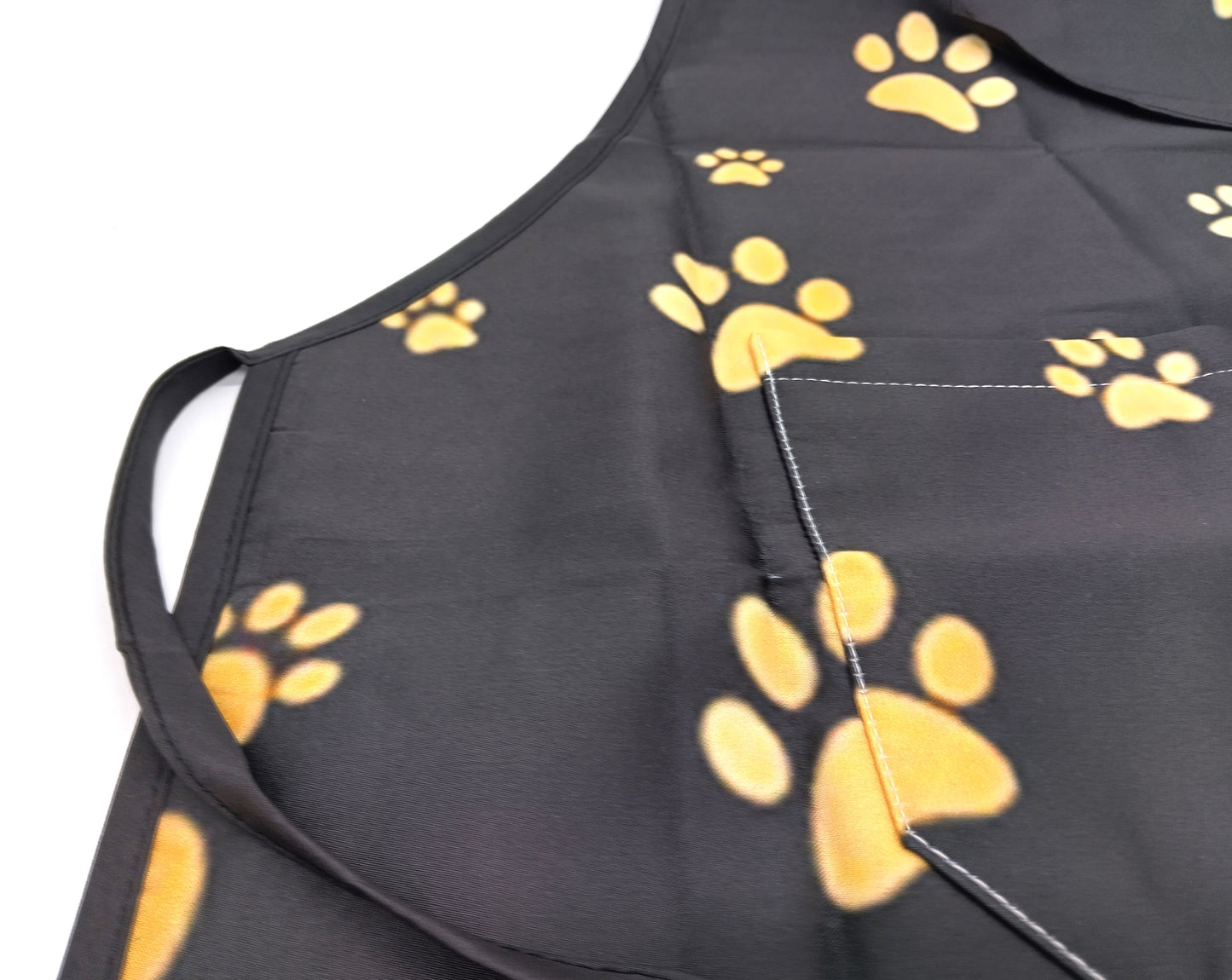 Kitchen Apron. Add a touch of style and functionality to your kitchen with the Gold Dog Paw Prints Kitchen Apron.