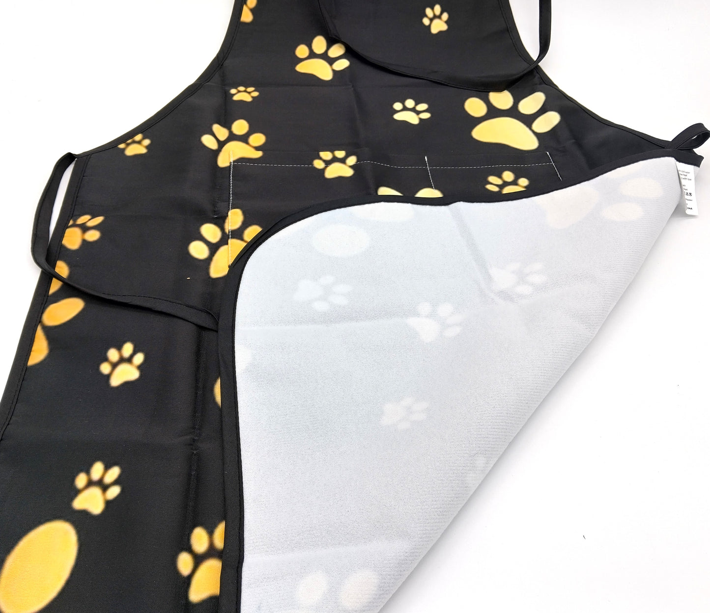 Kitchen Apron. Add a touch of style and functionality to your kitchen with the Gold Dog Paw Prints Kitchen Apron.